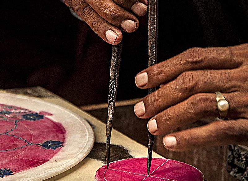 Artisan shaping semi-precious stone for inlay